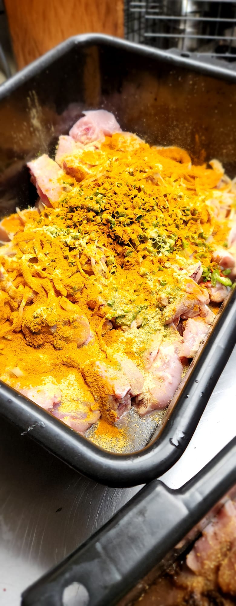 Curry chicken being seasoned