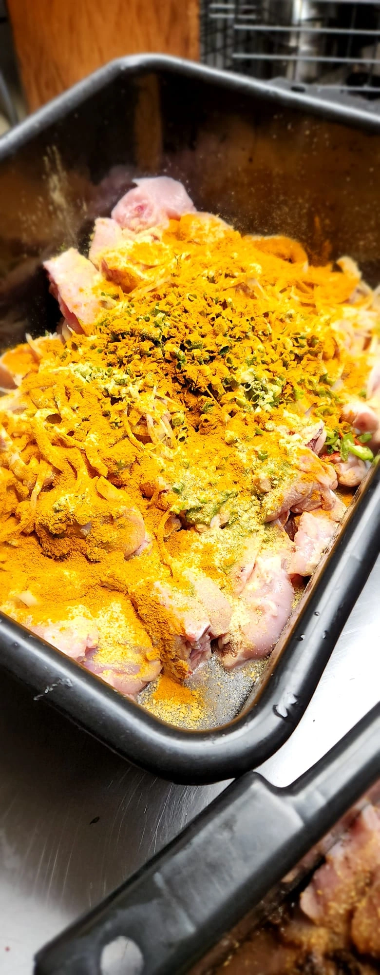 Curry chicken being seasoned